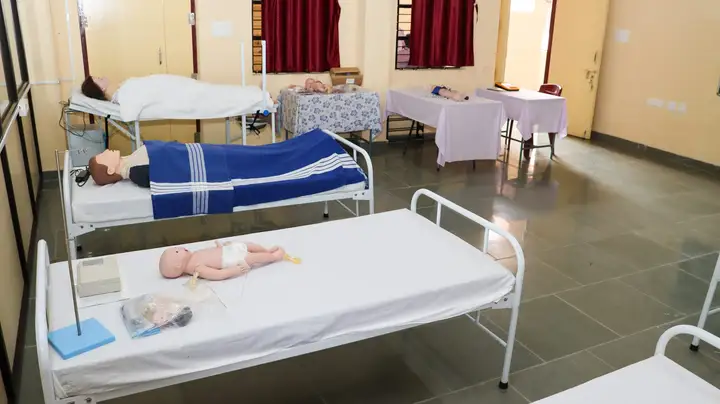 Practice manikins of an adult and a newborn baby on beds